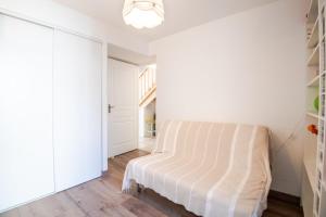 a white bedroom with a bed in a room at Peace and quiet in the heart of the city in Tours