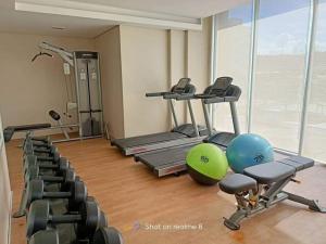 a gym with tread machines and exercise balls in a room at Riz's 2BR & 1T/Bath Condo 8 Spatial Maa 3f in Davao City
