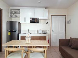 a small kitchen with a table and a couch at Riz's 2BR & 1T/Bath Condo 8 Spatial Maa 3f in Davao City