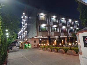 a large building with lights in front of it at night at Hotel Maya international in Jaipur