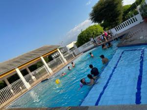 a group of people playing in a swimming pool at Casa Conjunto Rosario Norte 2 in Valledupar