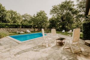 a patio with chairs and a swimming pool at Bed and Breakfast Kolo Adults only in Novigrad Istria
