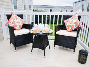 a patio with two chairs and a table with food on it at 32 Holiday Resort Unity in Brean