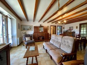a living room with a couch and a table at Gîte Saint-Haon, 4 pièces, 5 personnes - FR-1-582-211 in Saint-Haon