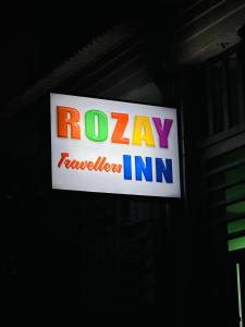 een bord voor een Rolex TV in een gebouw bij Rozay Travellers Inn in Kabankalan