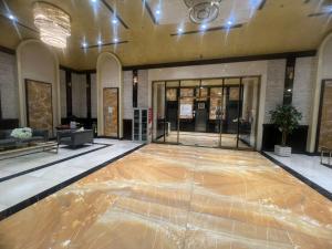 a lobby with a wooden floor in a building at Ocean View Luxury Suites in Ajman 