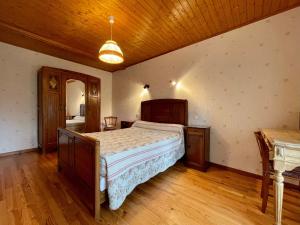 a bedroom with a large bed and a wooden ceiling at Gîte Saint-Jeures, 5 pièces, 8 personnes - FR-1-582-254 in Saint-Jeures