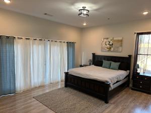 a bedroom with a bed and a large window at Decatur Delight Mixed- Use Apartments! in Decatur