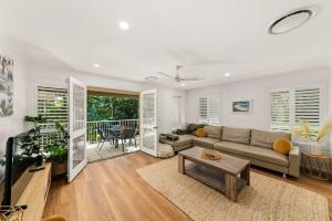 a living room with a couch and a table at Large Noosaville Gem - Off Gympie Terrace in Noosaville