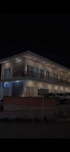a large white building with a balcony at night at Aesthetic Bromo Triple A Tour Family Room, Ngadisari, Probolinggo PARTNER, Additional Jeep Bromo Sunrise by Triple A Tour in Ngadisari