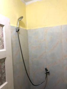 a shower in the corner of a bathroom at Countryside Schoolstay in Takeo