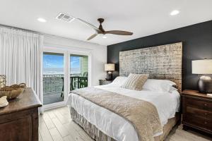 a bedroom with a large bed and a balcony at Grand Caribbean 4007 in Port Aransas +31 photos