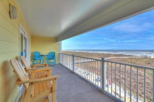 a balcony with chairs and a view of the beach at Grand Caribbean 4007 in Port Aransas