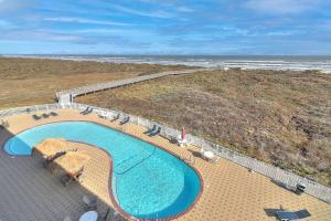 an overhead view of a swimming pool next to the beach at Grand Caribbean 4007 in Port Aransas