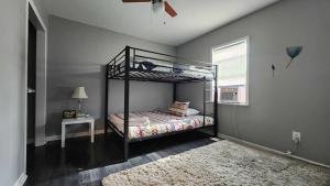 a bedroom with a bunk bed and a window at Swanky 3 Bedroom 2 5 Bath with King Bed Parking in Louisville