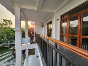 a porch of a house with a balcony at Regno Villa the Infinity by Nflix in Panadura
