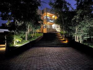 a building with stairs leading up to it at night at The KWASU Apartments in Chipata