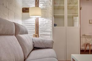 ein Wohnzimmer mit einem Sofa und einer Lampe in der Unterkunft Dúplex Portales By Clabao in Logroño