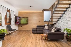 a living room with a couch and a staircase at Villa Kum in Tuk Vojni