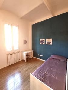 a bedroom with a bed and a desk in it at Suite Del Parco in Bologna