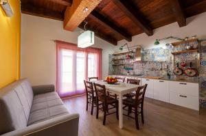 a kitchen and dining room with a table and chairs at Holiday Mulas in Marina di Casalvelino