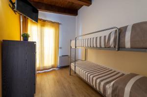 a room with two bunk beds and a television at Holiday Mulas in Marina di Casalvelino +8 photos