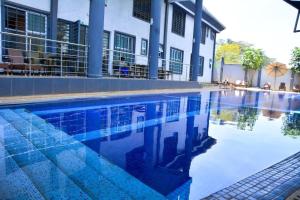 a swimming pool in front of a building at The Moon Apartments in Mutomo