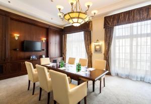 a dining room with a table and chairs and a television at Radisson Blu Hotel, Gdańsk in Gdańsk