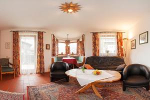 a living room with a couch and a table at Frühlingshof in Reit im Winkl