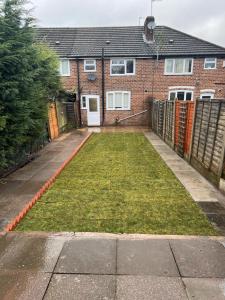 a yard in front of a brick house at The Ideal Beautiful 3-Bed House in Birmingham in Birmingham