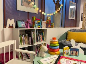 a childs room with a book shelf filled with books at Mercure Toulouse Centre Saint-Georges in Toulouse