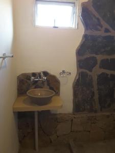 a bathroom with a stone sink and a window at 4 ELEMENTOS in Huacalera