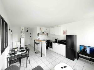 a kitchen with a black refrigerator and a table at Mickey's house - Apartments 4 persons - 10 min Disneyland Paris in Bussy-Saint-Georges