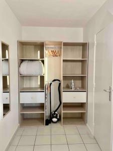 a bathroom with a walk in closet with shelves at Mickey's house - Apartments 4 persons - 10 min Disneyland Paris in Bussy-Saint-Georges