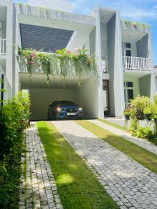 a car parked under a garage in a house at OESIS - Stylish Holiday Home in the heart of Galle in Galle