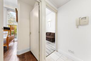 a mirror in a hallway with a living room at Cozy Apartment in Bayswater in London