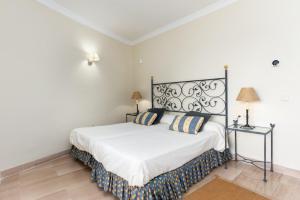 a bedroom with a white bed with two pillows at Charming Marbella in Marbella