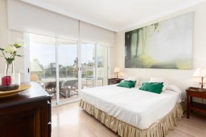 a bedroom with a large bed with green pillows at Charming Marbella in Marbella