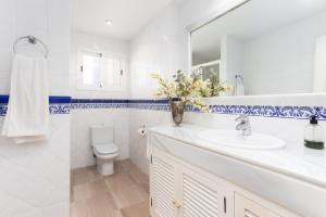 a bathroom with a sink and a toilet and a mirror at Charming Marbella in Marbella +31 photos