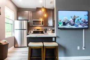 a kitchen with a tv hanging on the wall at Travel-Nurses & Professionals-Stay Close to it All in San Diego