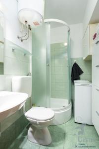 a white bathroom with a toilet and a shower at Apartment May in Split