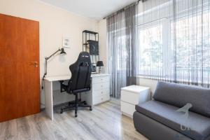 a bedroom with a desk and a chair and a desk at Apartment May in Split
