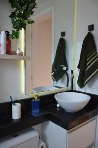 a bathroom with a sink and a bowl on a counter at Apartamento Marilândia Juiz de Fora in Juiz de Fora