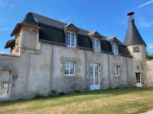 an old house with a tower on top of it at Maison spacieuse avec jardin privatif, idéale pour 6, proche Orléans et Châteaux de la Loire - FR-1-590-236 in Loury