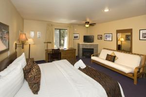 a bedroom with a large bed and a living room at Holiday Haus in Mammoth Lakes