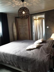 a bedroom with a bed with two pillows on it at Happiness Cottage in Colmar