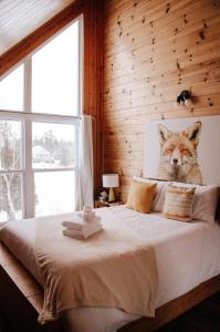 1 dormitorio con cabeza de lobo en la cama en Chalet Le Huard, en Weedon-Centre
