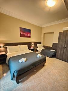 Postel nebo postele na pokoji v ubytování Hotel Romano