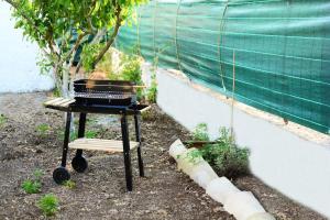 a grill sitting on a table in a garden at Violisa Charme in Castellammare del Golfo