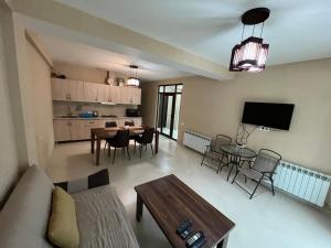 a living room with a couch and a table at Cottage Crystal Bakuriani in Bakuriani